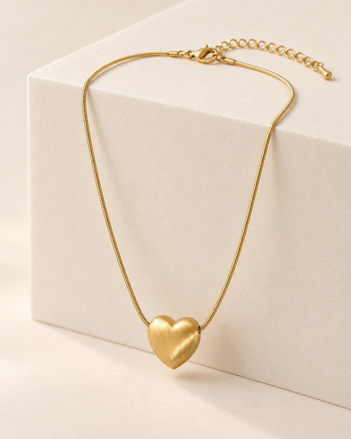 Héloïse brushed matte heart pendant necklace on snake chain in Gold, side view