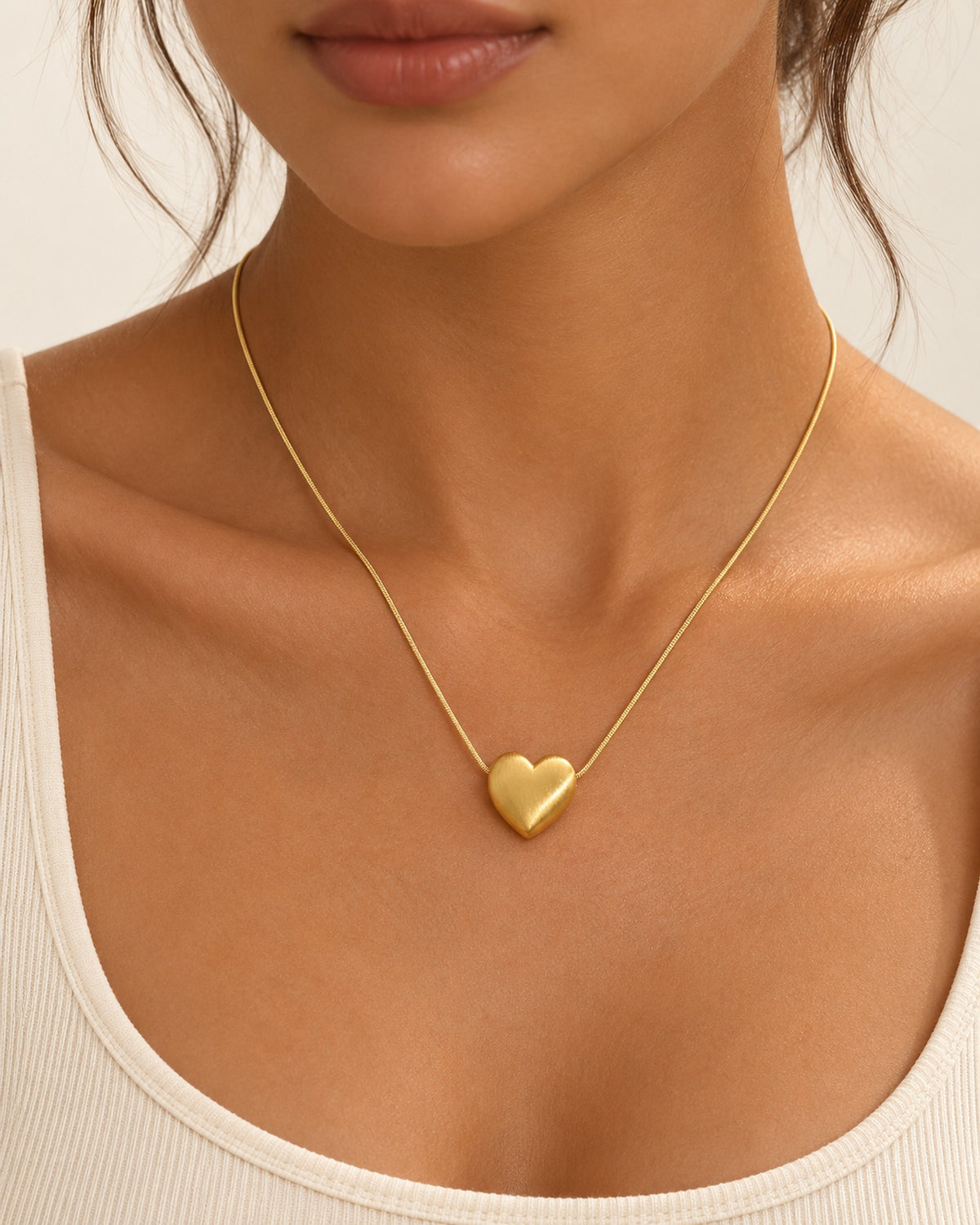 Héloïse brushed matte heart pendant necklace on snake chain in Gold, worn
