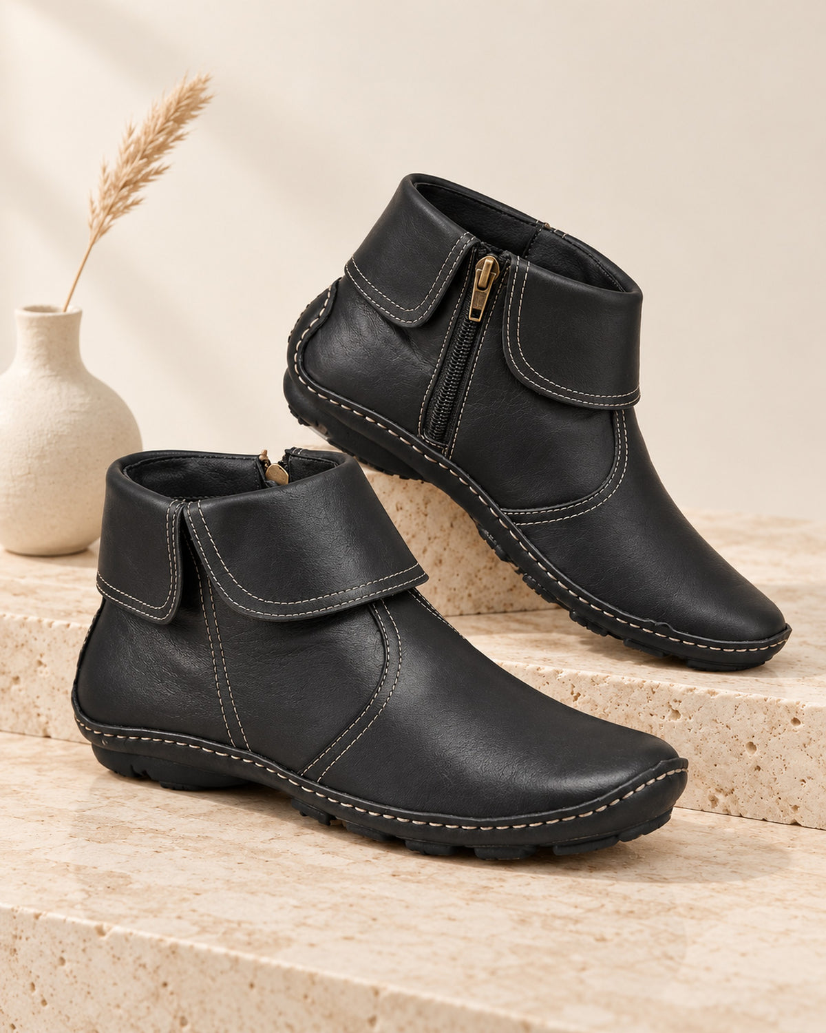 Margaux fold-over cuff ankle boot with side zip in Black, still life on travertine