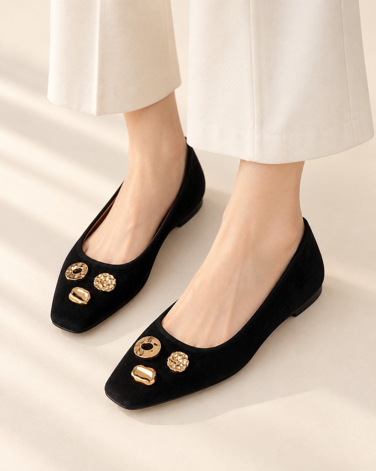 Apolline suede square-toe flat with gold-tone ornaments in Black, worn