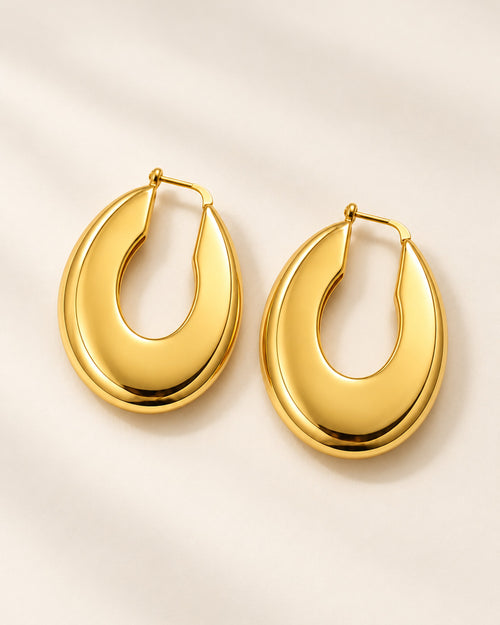 Aurélie sculpted oval hoop earrings in Gold, three-quarter view