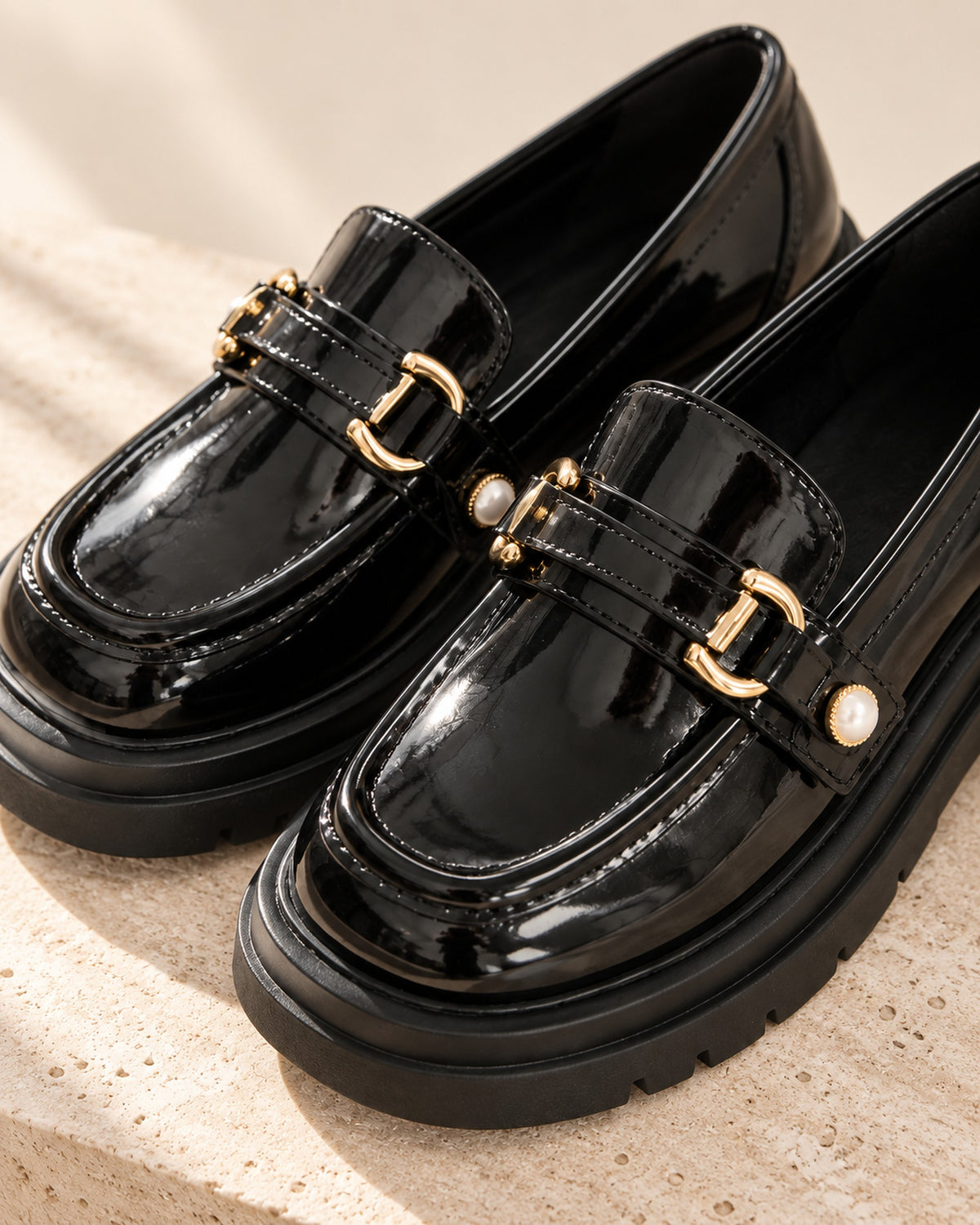 Bérénice patent-finish platform loafer with horsebit buckle in Black, close-up detail