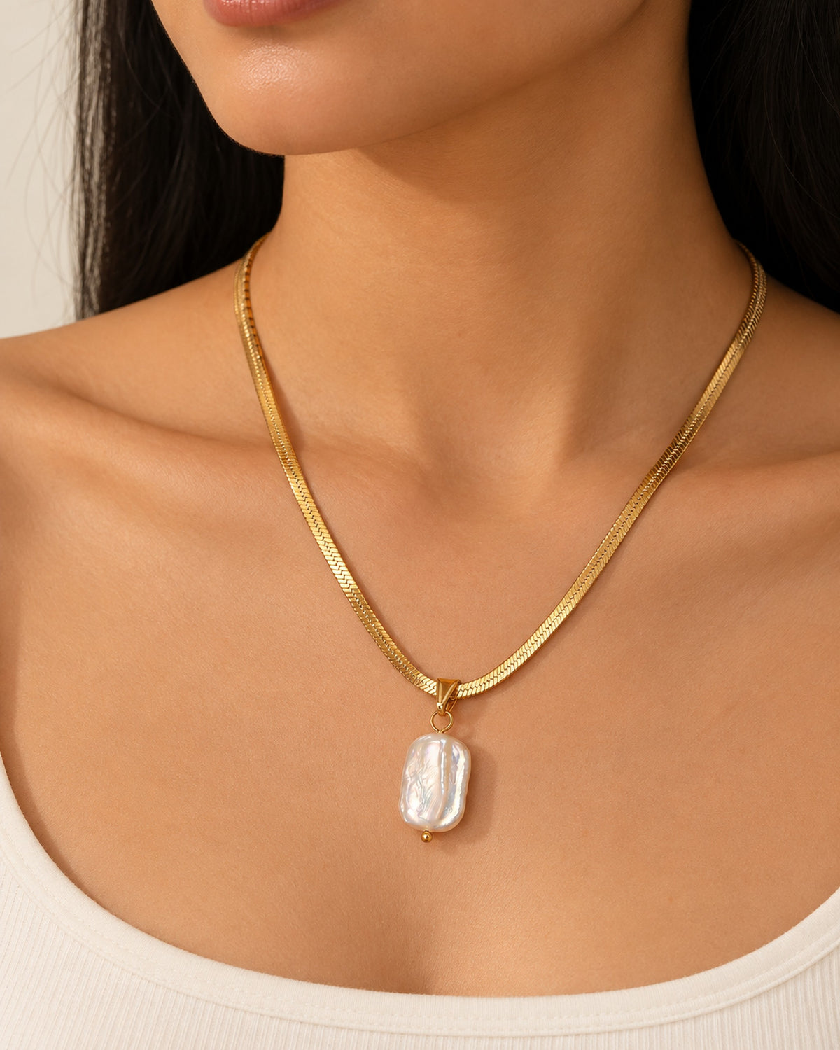 Celeste gold-tone herringbone chain necklace with baroque pearl drop, worn