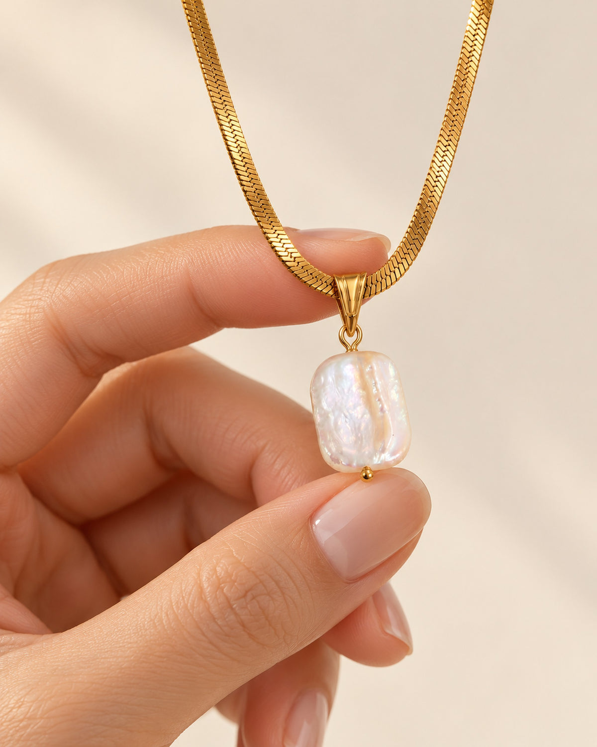Celeste gold-tone herringbone chain necklace with baroque pearl drop, shown to scale