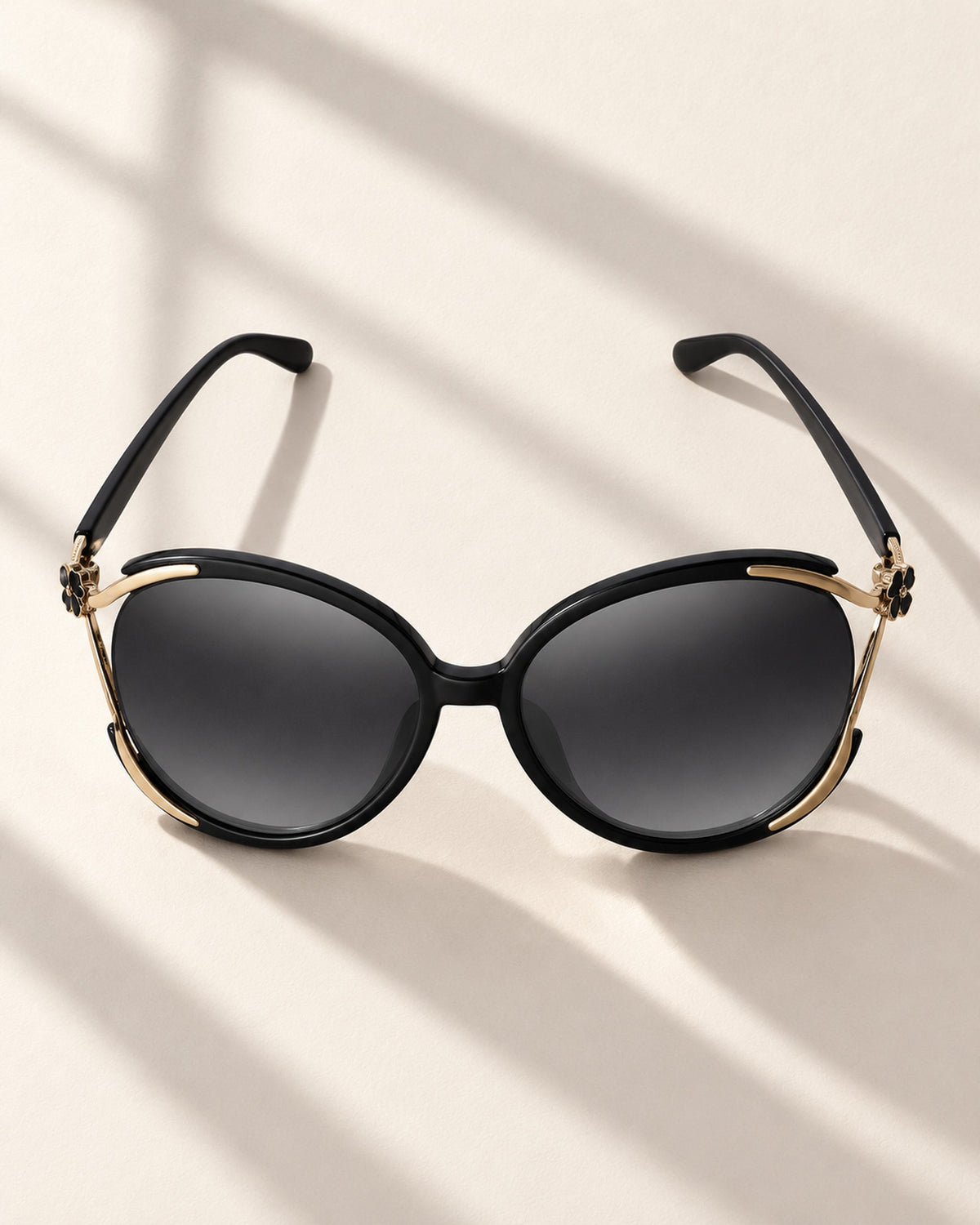 Chiara cat-eye sunglasses in black frame, gray gradient lenses, overhead view