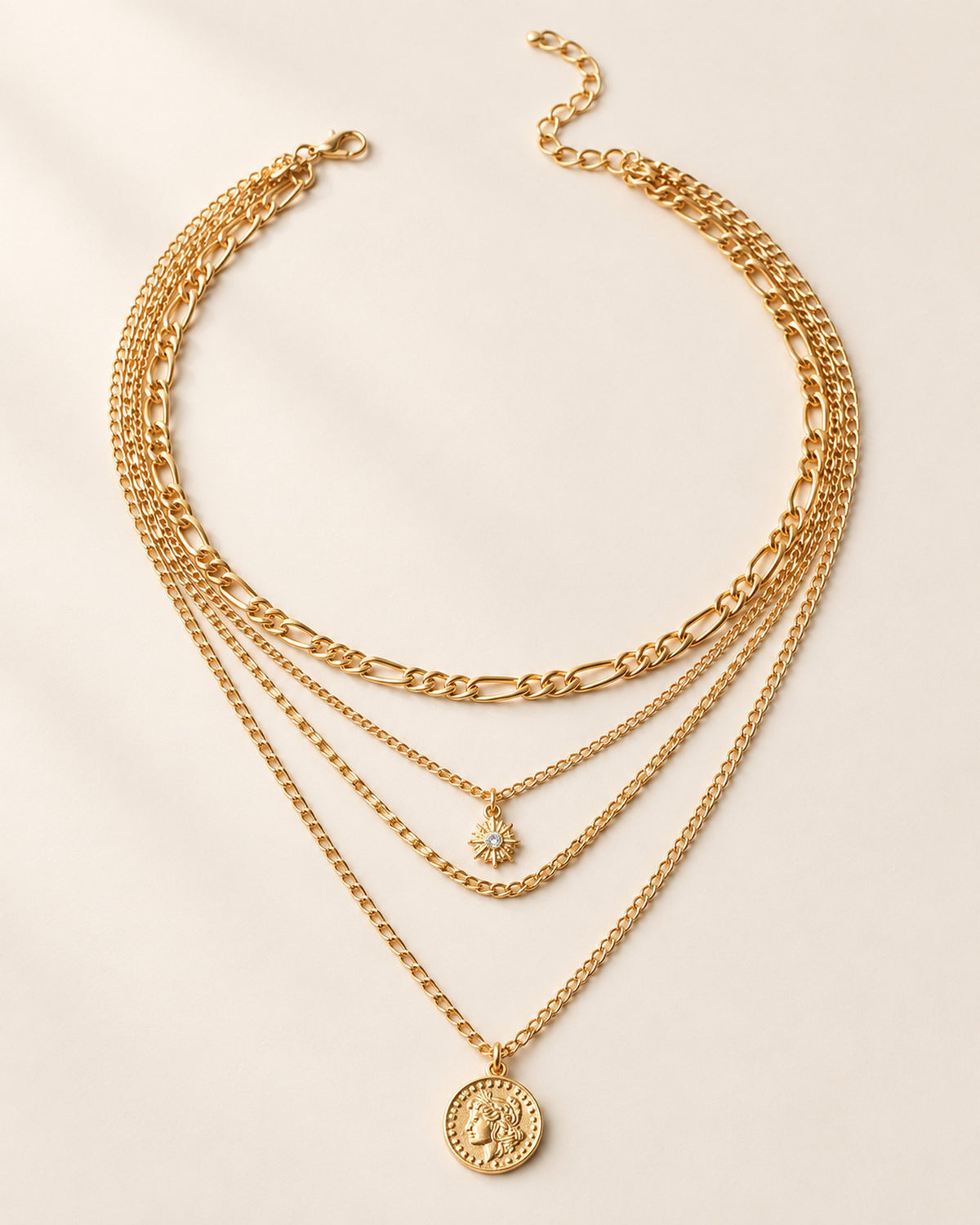 Colette four-strand layered necklace with sun charm and coin medallion in Gold, three-quarter view