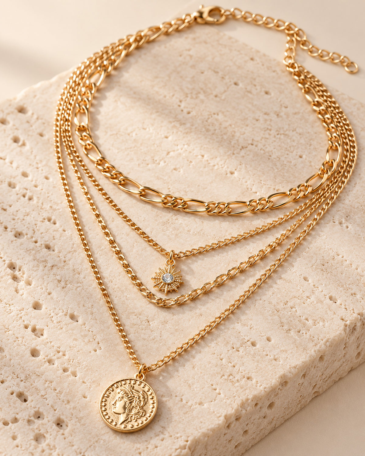 Colette four-strand layered necklace with sun charm and coin medallion in Gold, close-up detail