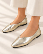 Sélène metallic crinkle-finish V-cut ballet flat in Gold, worn