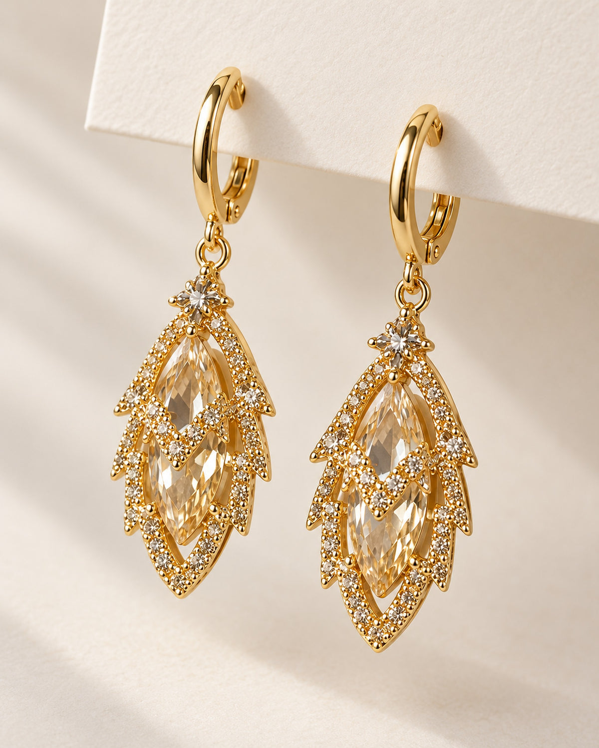 Iris zircon leaf drop earrings on gold-tone huggie hoops in Gold, side view