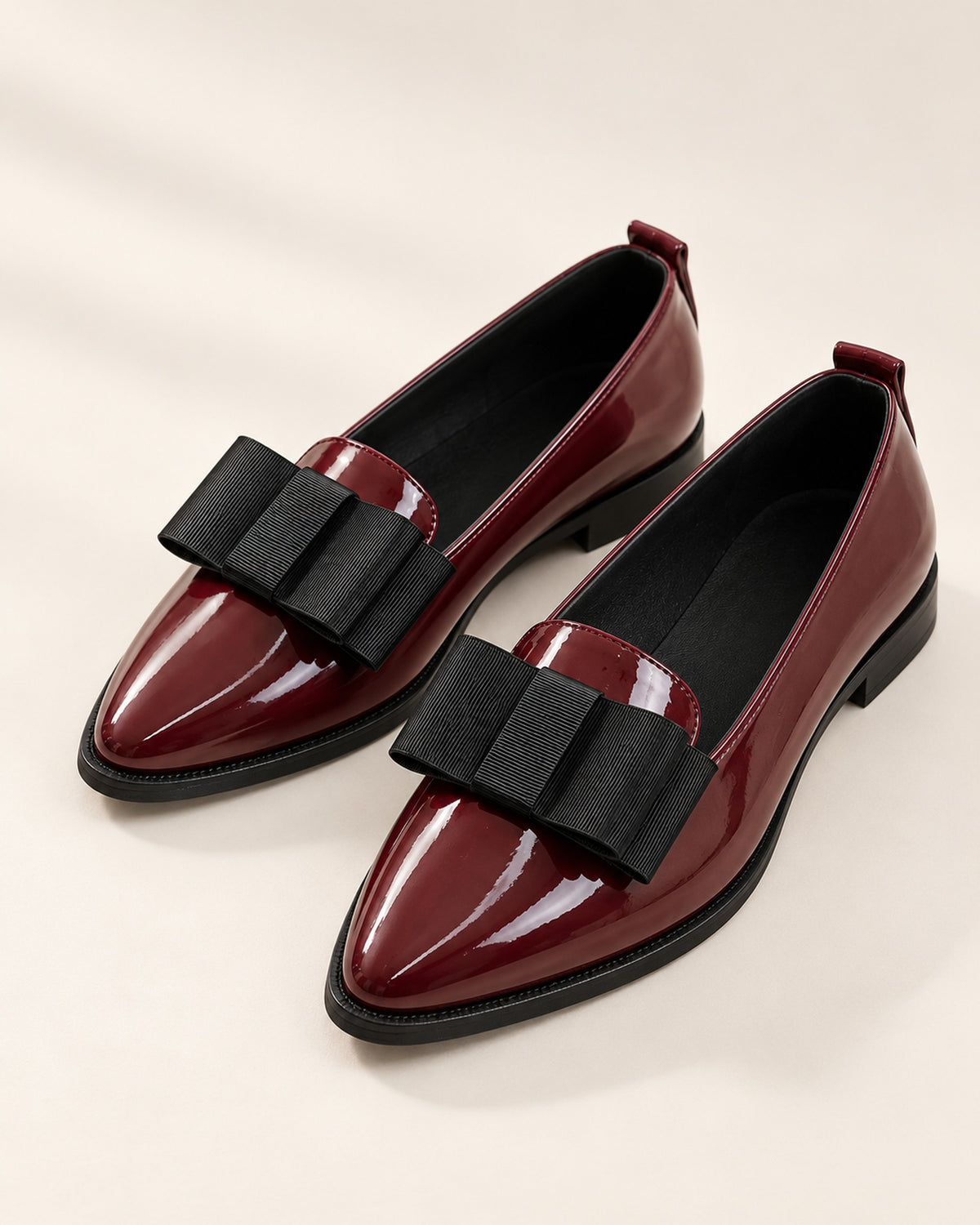 Léa patent-finish pointed ballet flat with oversized bow in Burgundy, three-quarter view
