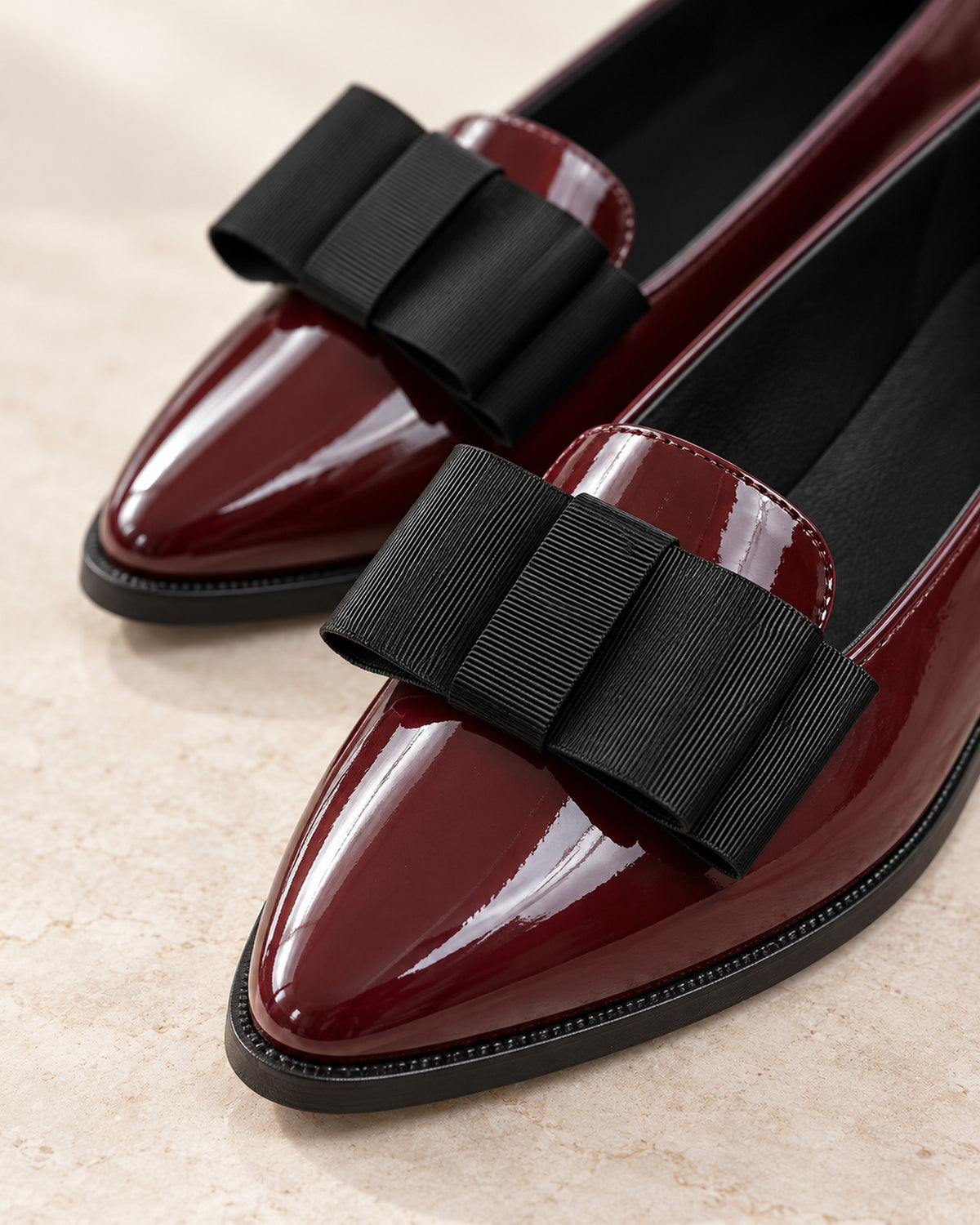 Léa patent-finish pointed ballet flat with oversized bow in Burgundy, close-up detail