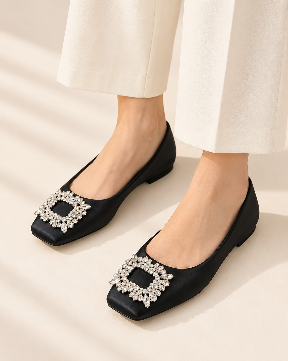 Lysiane square-toe flat with rhinestone buckle in Black, worn