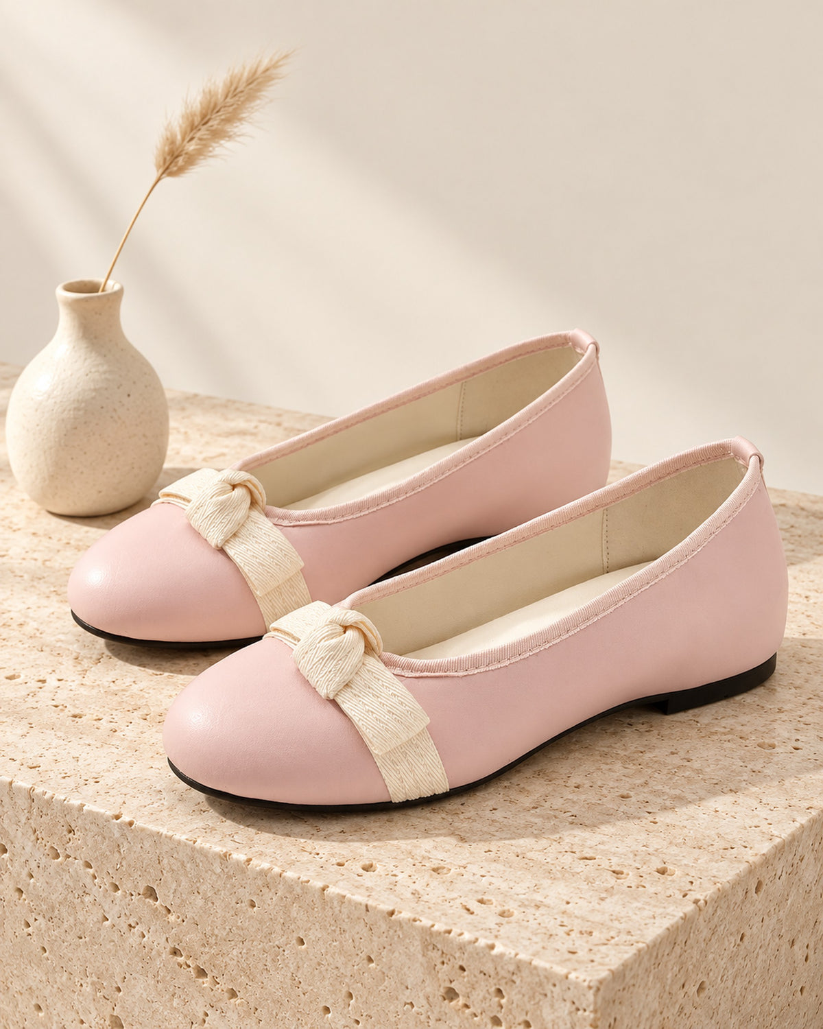 Mireille round-toe ballet flat with grosgrain bow in Pink, still life on travertine