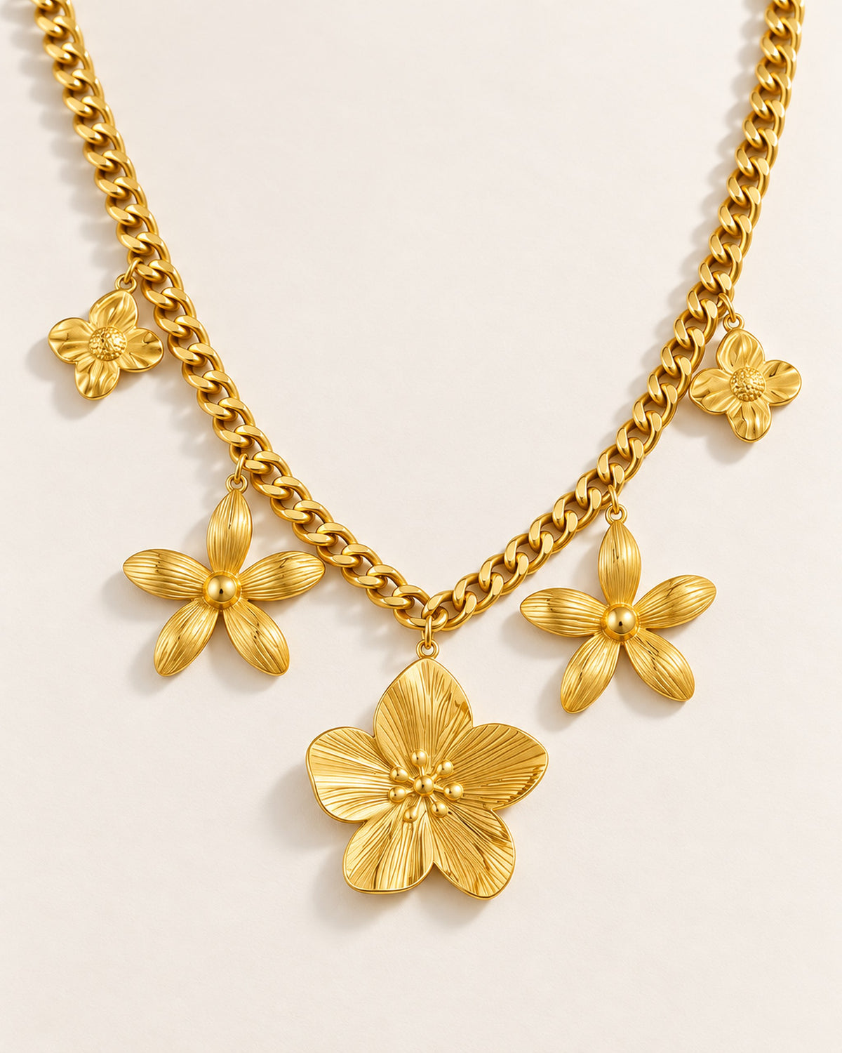 Octavie stainless steel curb chain necklace with five flower charms in Gold, three-quarter view