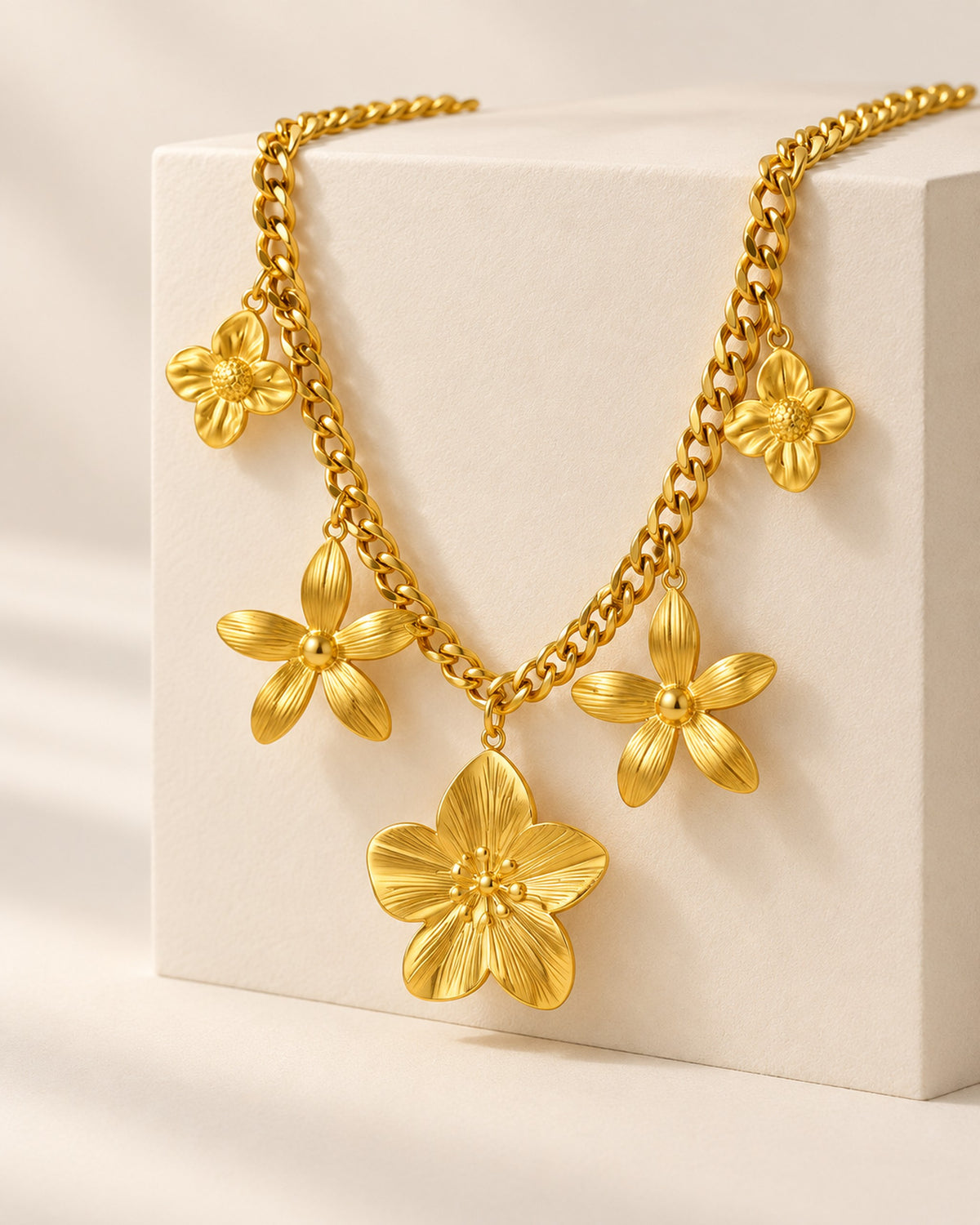 Octavie stainless steel curb chain necklace with five flower charms in Gold, side view