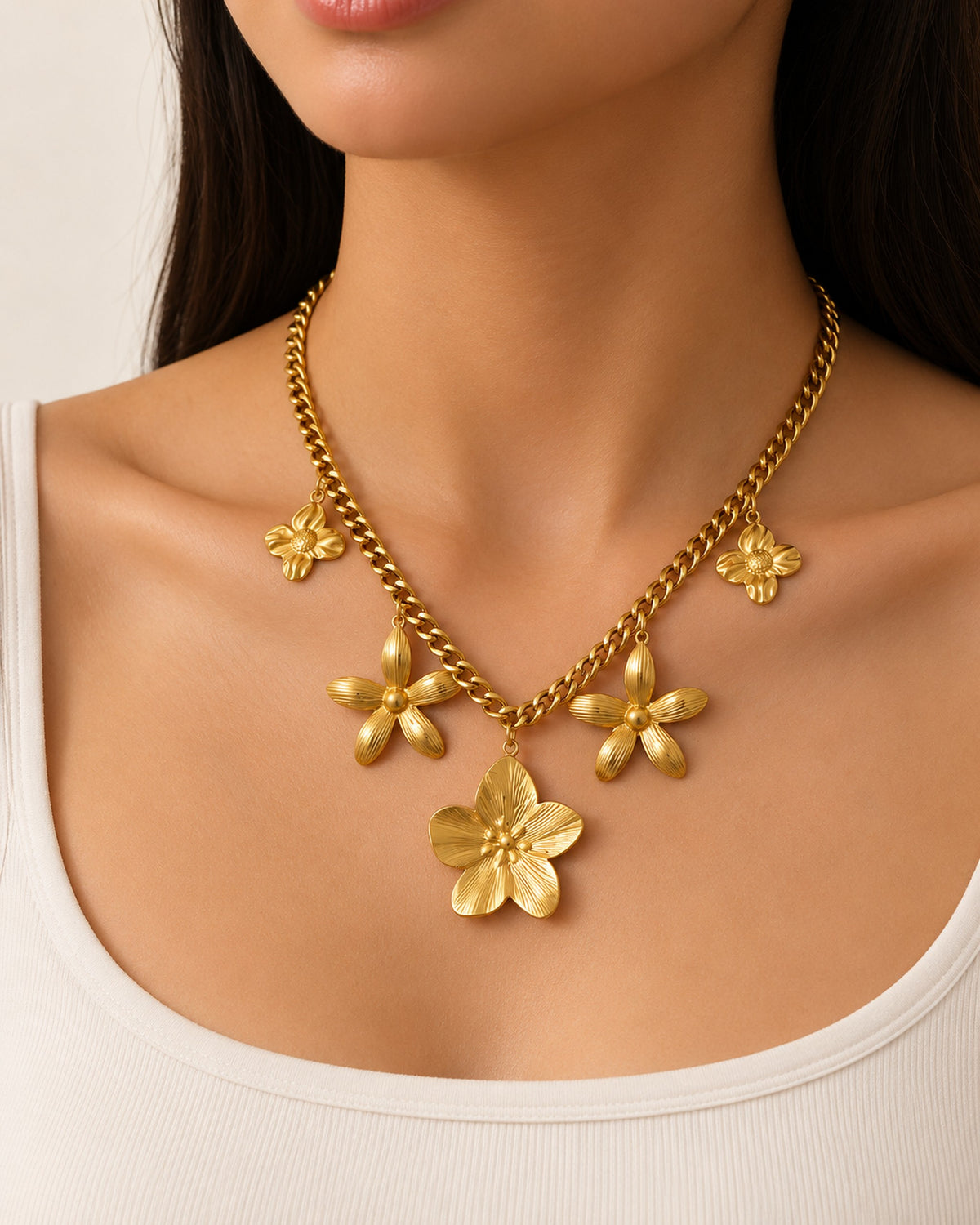Octavie stainless steel curb chain necklace with five flower charms in Gold, worn